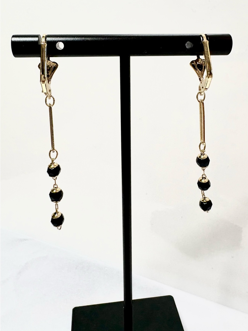 Stylish 18k PVD Gold-Tone Drop Earrings with Black Beads.